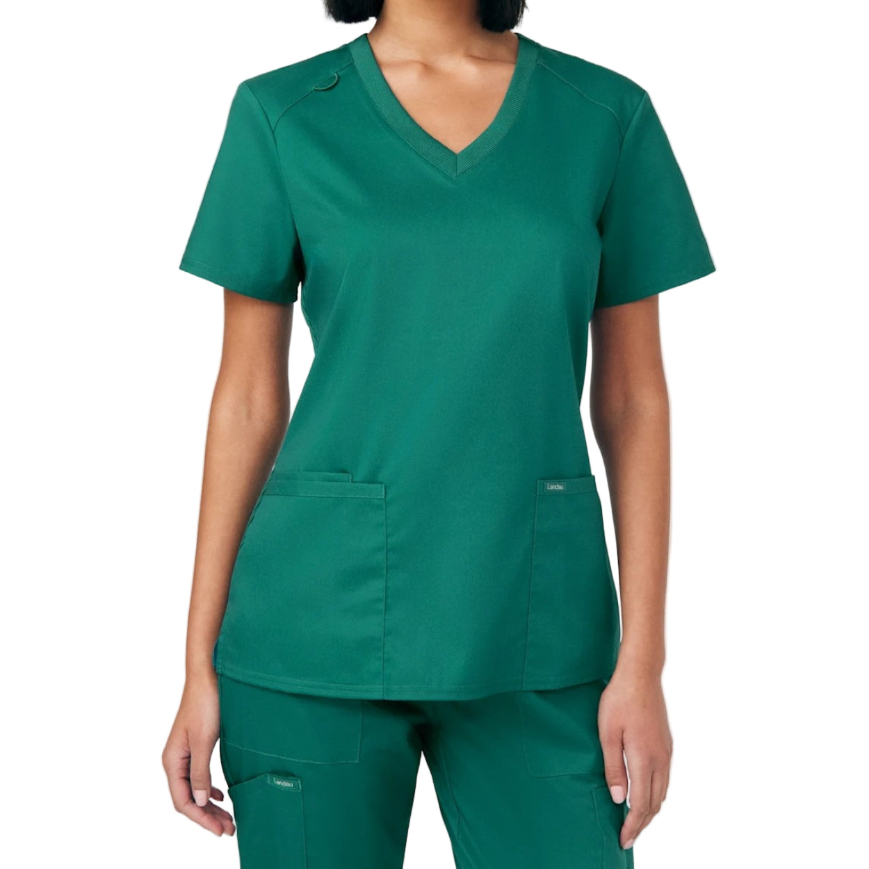 Hunter green scrub top on a white background